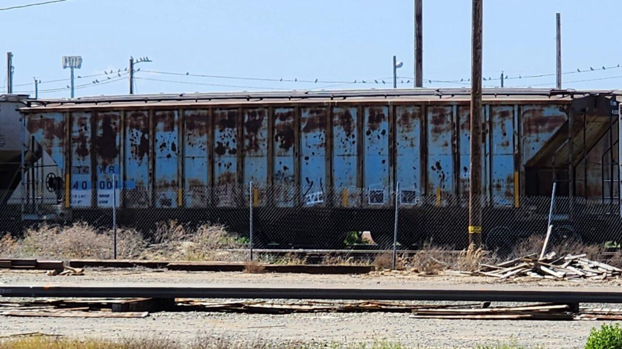 AN OLDER STYLE 3 BAY HOPPER WITH LOTS OF RUST