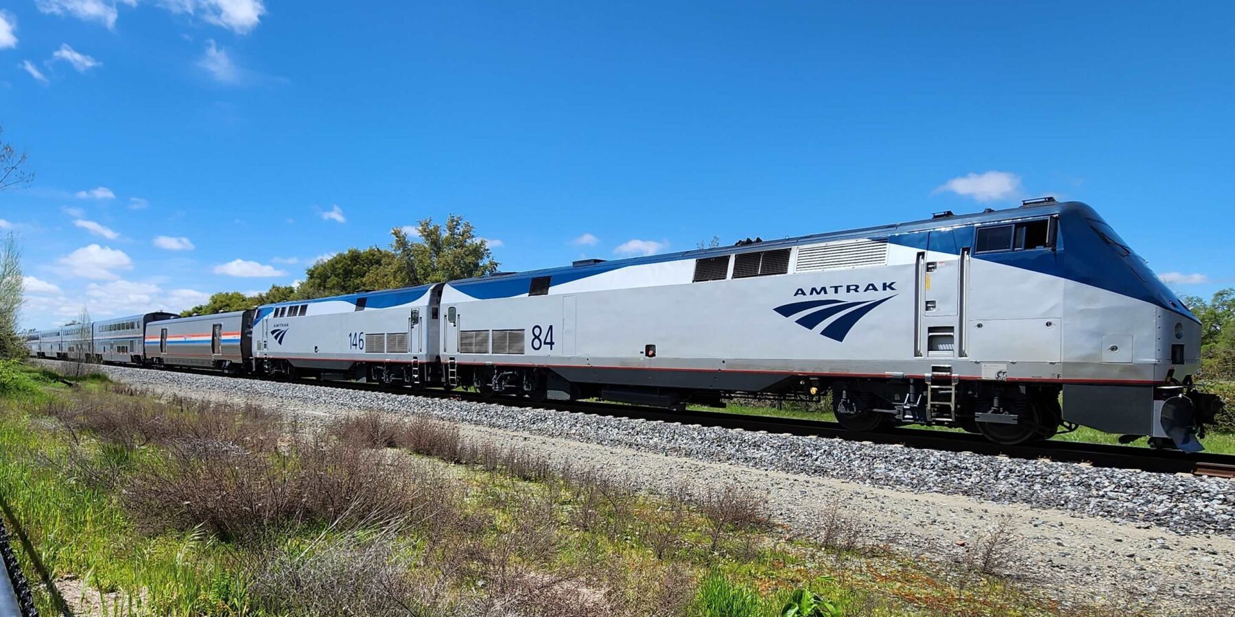 AMTRAK LOCOMOTIVES 84 AND 146 LEAD A AN EASTBOUND TRAIN IN LOOMIS CALIFORNIA.