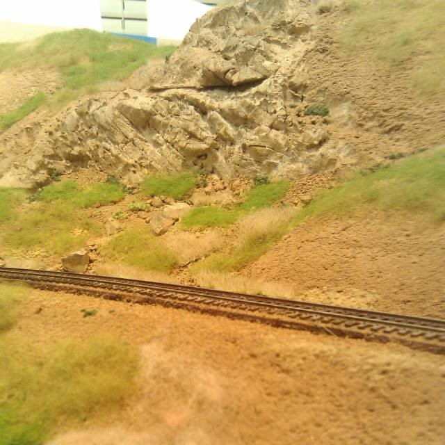 A SCENE ON MY MODEL RAILROAD SHOWING SOME VERY REALISTIC MODEL RAILROAD ROCKS CARVED INTO THE MOUNTAINSIDE.