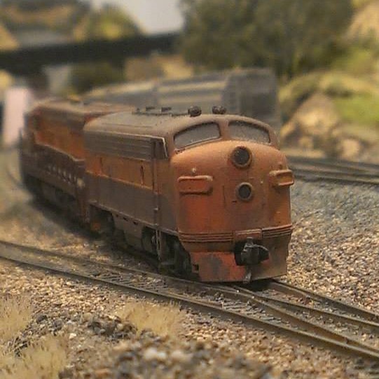 A KATO F7 LOCOMOTIVE IN A CUSTOM PAINT SCHEME ON MY N SCALE MODEL RAILROAD.