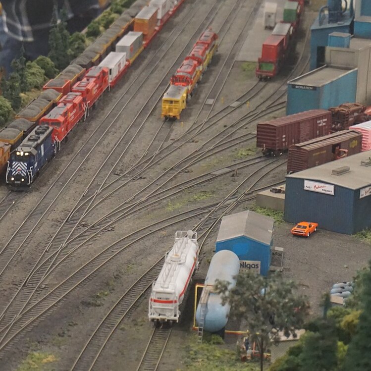 A PHOTO OF AN INDUSTRIAL AREA AND SOME YARD TRACKS ON THE WISCONSIN AND MICHIGAN MODEL RAILROAD CLUB LAYOUT