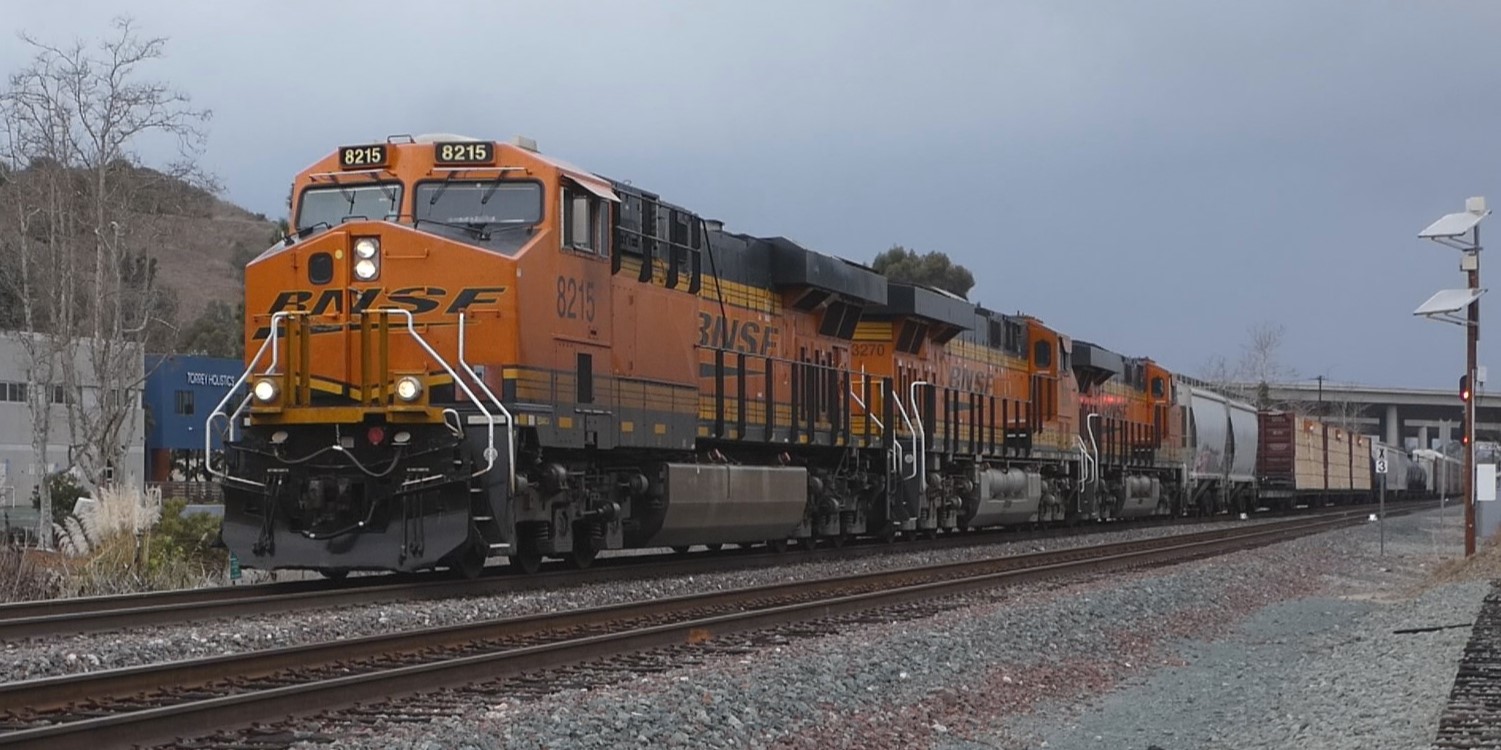 A BURLINGTON NORTHERN/SANTA FE FREIGHT TRAIN LED BY LOCOMOTIVE NUMBER 8215