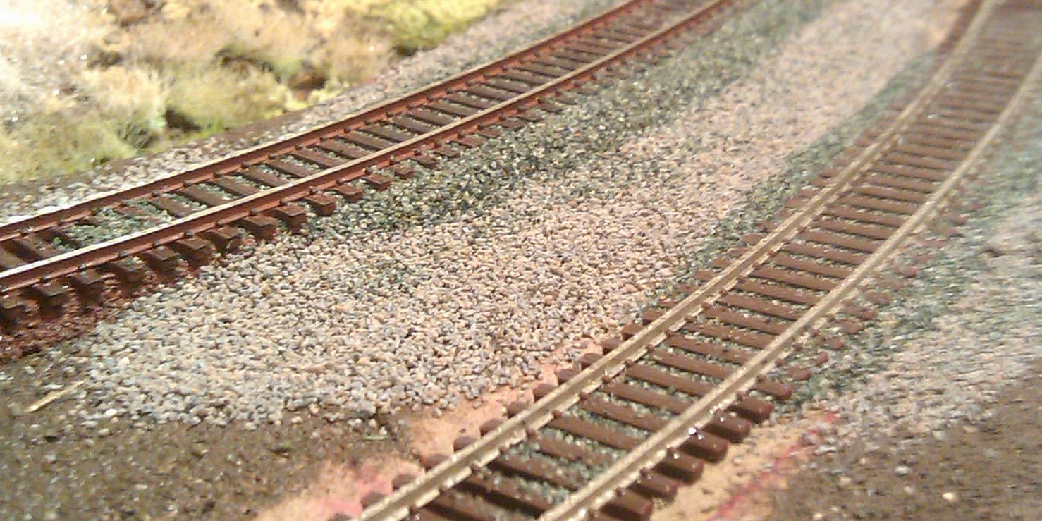 dark gray track ballast over a light gray sub ballast