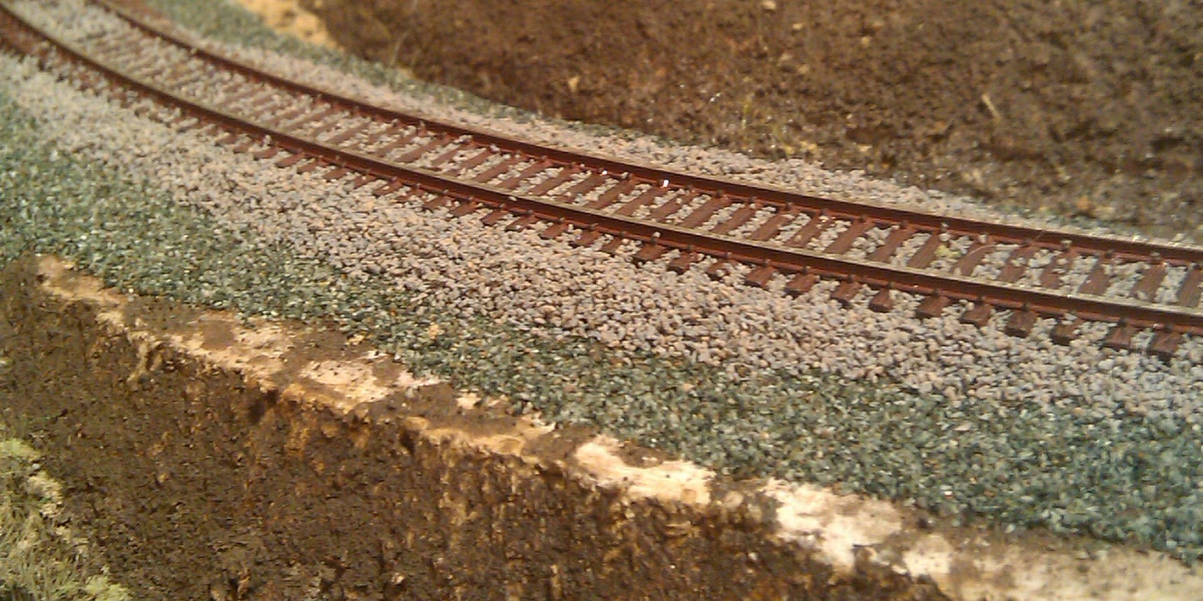 dark layer of sub ballast and a light layer of track ballast