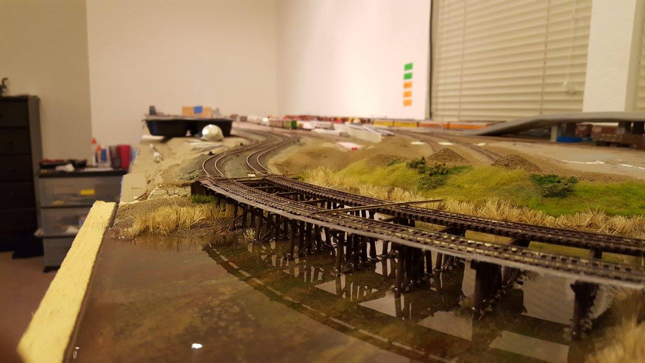 a trestle and water feature created below track level using 1" XPS foam base for a Model Railroad train table